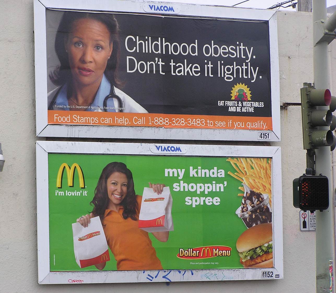 McDonald's billboard next to obesity prevention billboard