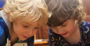 two kids looking down