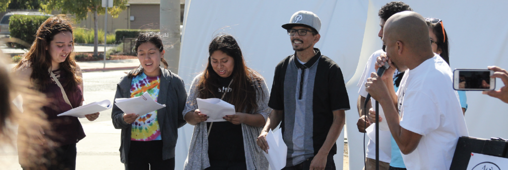 youth gathered and speaking into microphone