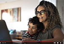 mom and son in front of a computer screen